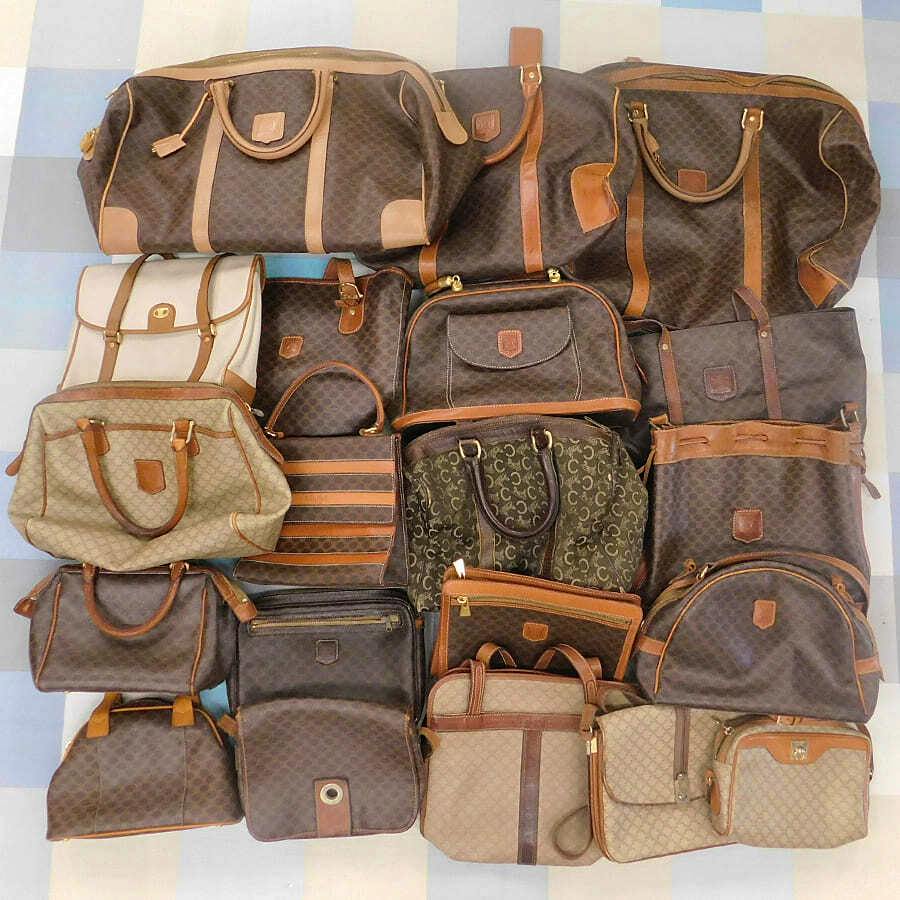 Multiple CELINE canvas bags in brown macadam patterns with leather trim arranged flat on a surface.