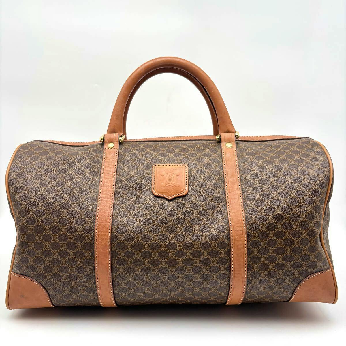 Front view of the CELINE brown Macadam-patterned Boston travel bag with tan leather handles and trim.