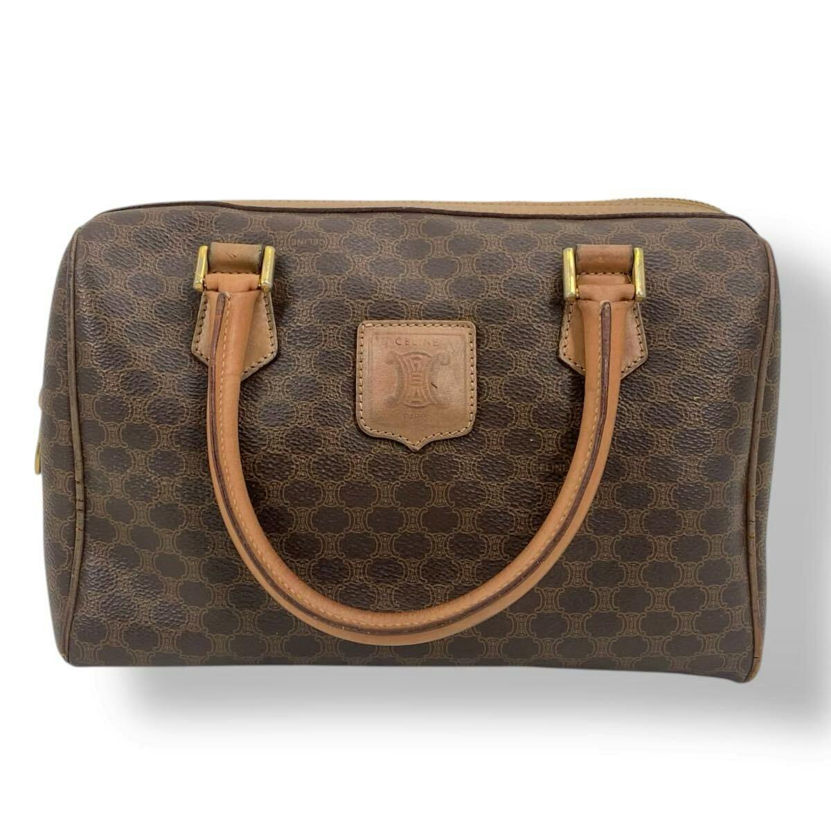 Front view of a brown CELINE Macadam-pattern mini boston handbag with leather handles and a front logo patch.