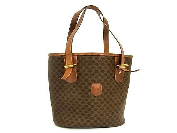 Front view of a brown CELINE Macadam-pattern PVC leather tote handbag with leather shoulder straps and gold-tone buckle details.