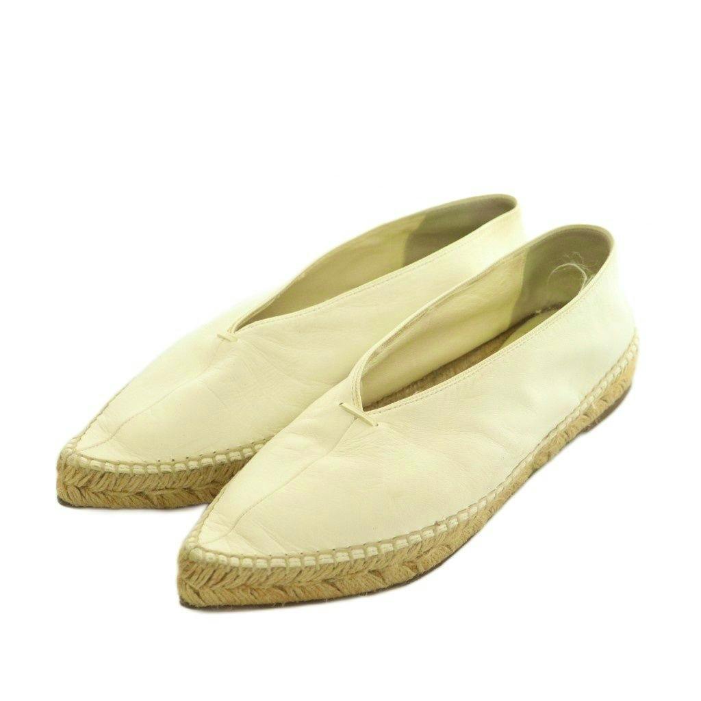 Pair of white leather pointed-toe espadrille shoes displayed on a white background.