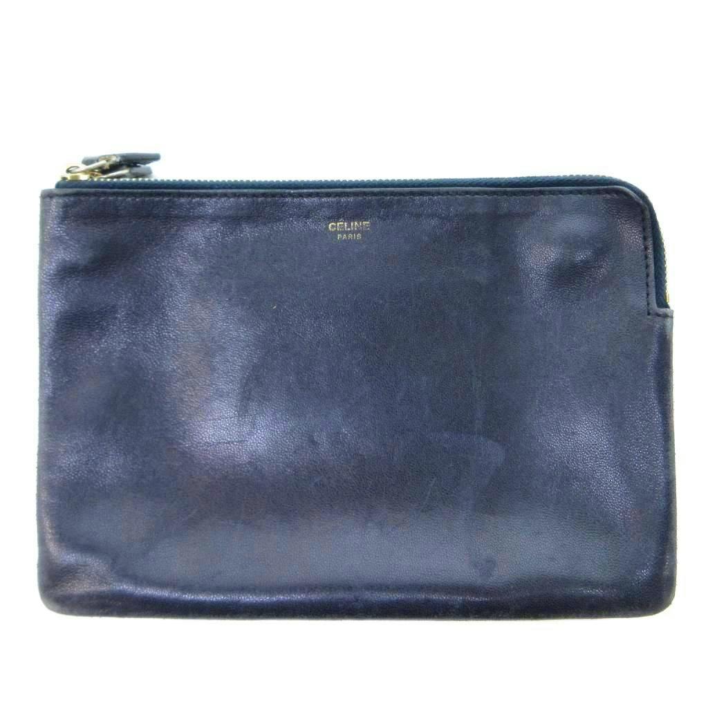 Front view of a navy CELINE zip pouch with gold CELINE PARIS logo stamp.