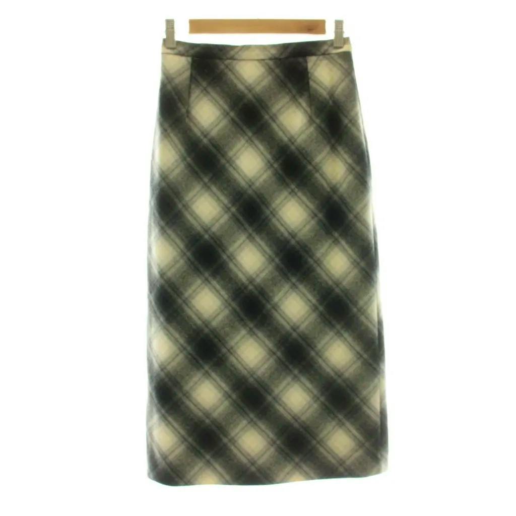 Gray and ivory checked mid-length wool tight skirt hanging on a wooden hanger against a white background.