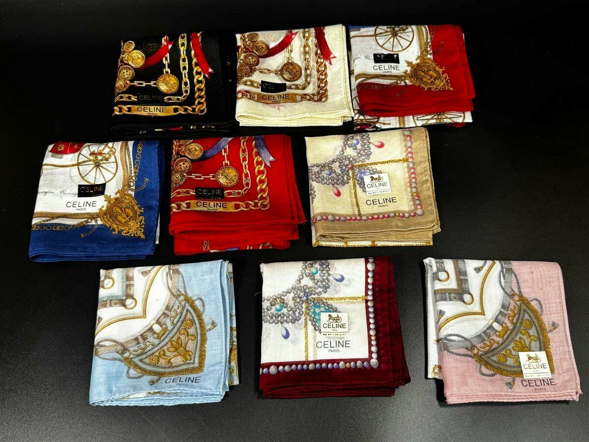 Nine folded CELINE silk handkerchiefs with assorted horse-carriage, chain, and jewelry prints on a black background.