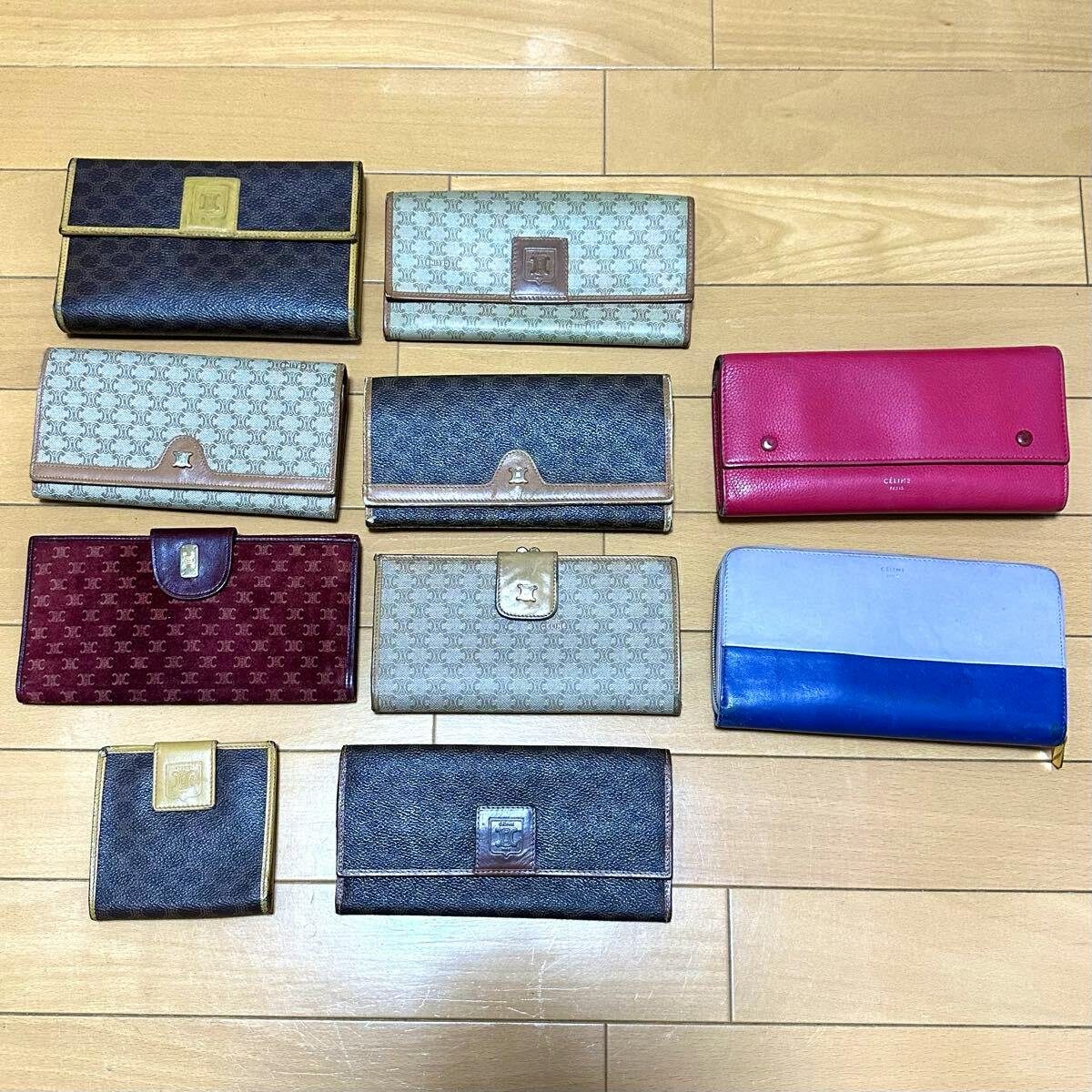 Ten CELINE wallets and small purses in various colors and patterns arranged on a wooden floor.