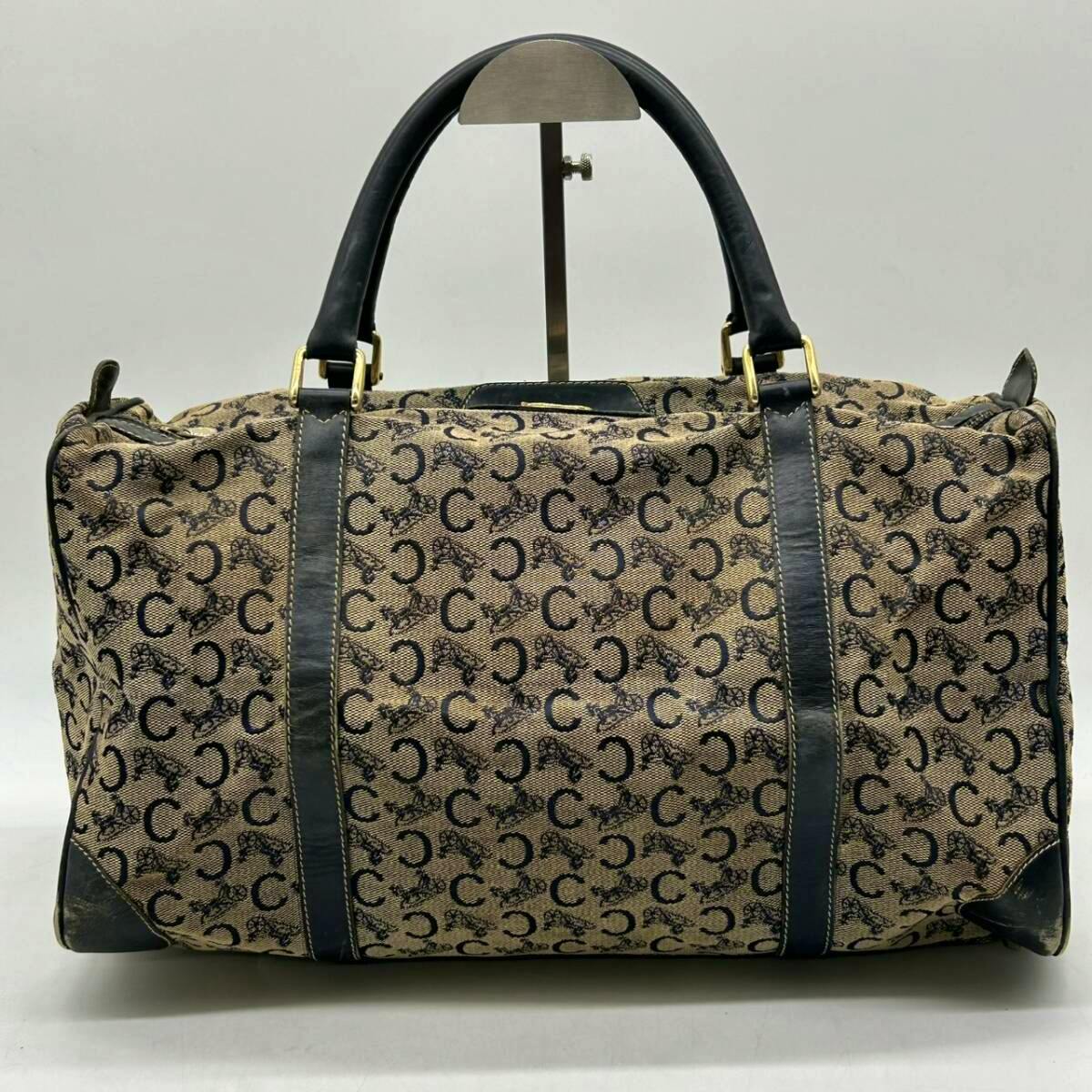 Front view of a CELINE canvas Boston/handbag with C-macadam pattern and leather handles.