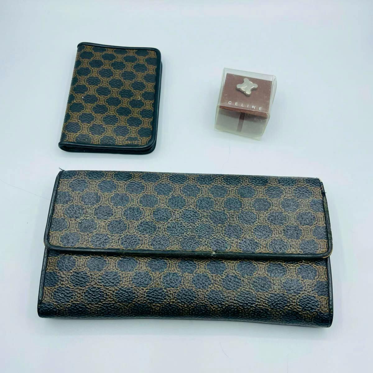 A CELINE vintage macadam-pattern long wallet with a matching pass case and a small boxed accessory on a white background.