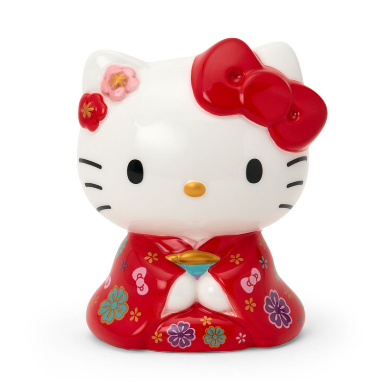 Front view of a ceramic piggy bank figure of a cat wearing a red kimono with floral decorations.