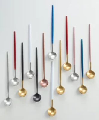 Several long-handled metal spoons with different colored handles arranged on a light background.