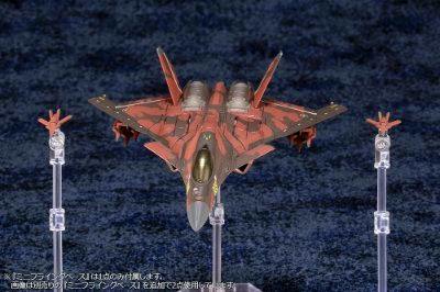 A CFA-44 plastic aircraft figure from the ACE COMBAT series displayed on clear stands against a dark textured background.