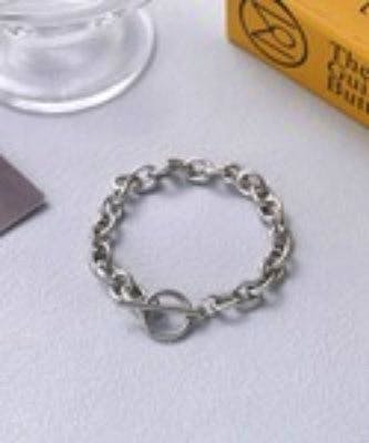 A chain-design bracelet with a toggle (mantel) clasp laid flat on a white surface.