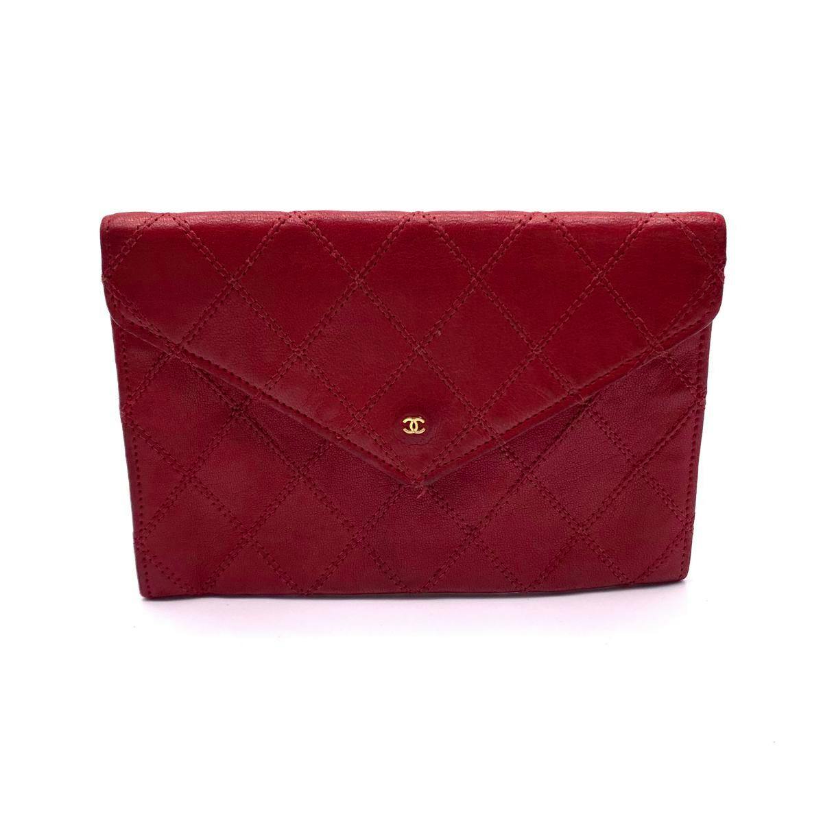 Front view of a red quilted lambskin CHANEL pouch wallet with a small gold CC logo on the flap.