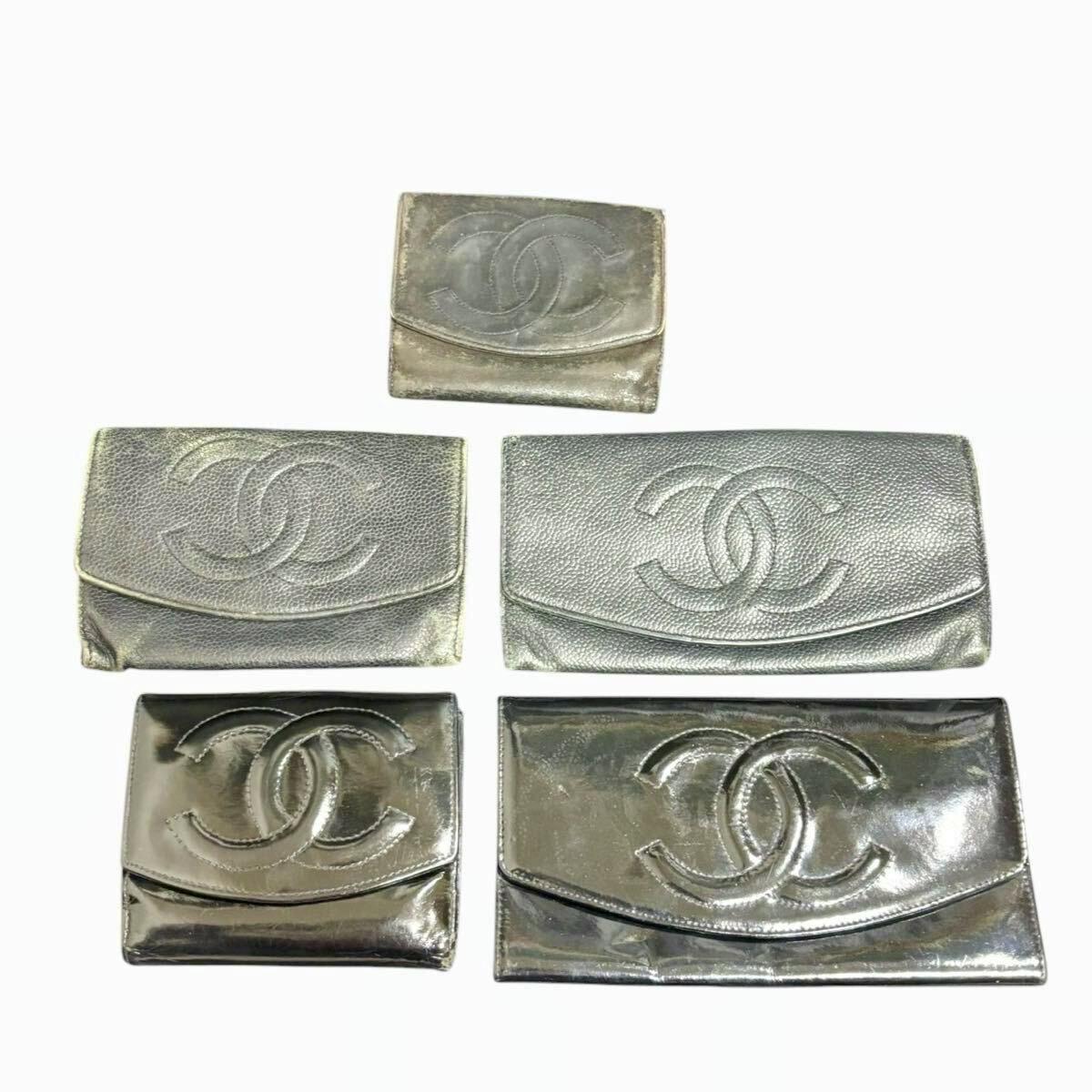 Five CHANEL wallets laid out on a white background, each showing a large interlocking CC logo on the flap.