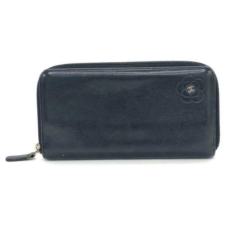 Front view of a CHANEL lambskin long zip-around wallet showing the camellia embossing and CC logo.