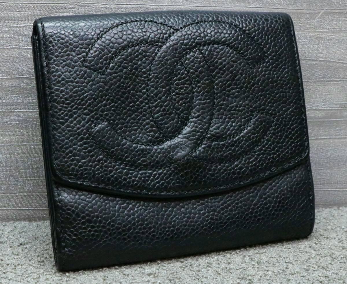 Front exterior of a black caviar leather bi-fold wallet showing a large stitched Chanel interlocking CC logo.