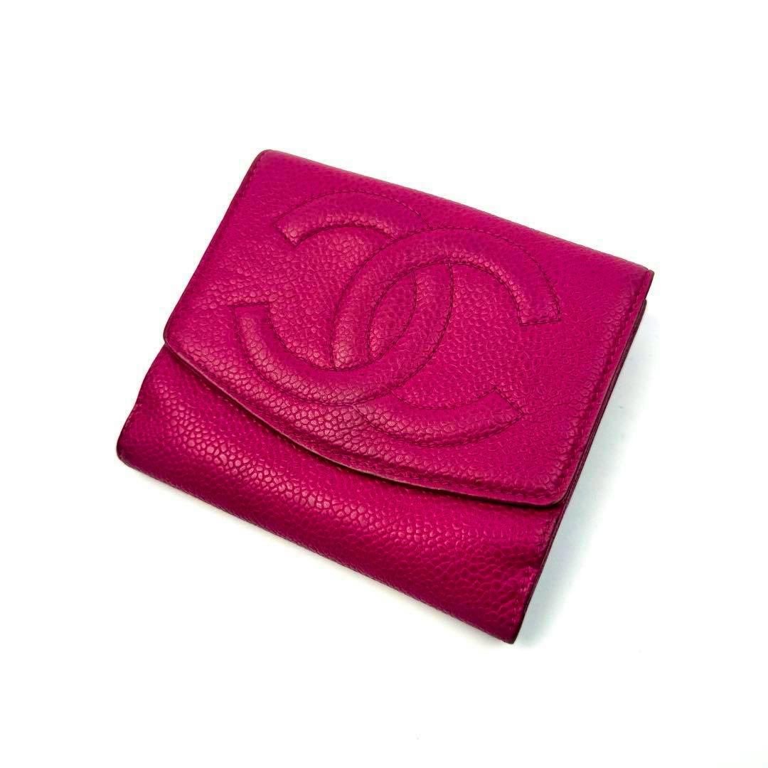 Folded pink CHANEL caviar-skin bi-fold wallet showing the front flap with an embossed interlocking CC logo.