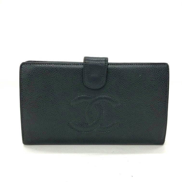Front view of the cow leather CHANEL bi-fold wallet showing an embossed interlocking CC logo and a snap-closure tab.