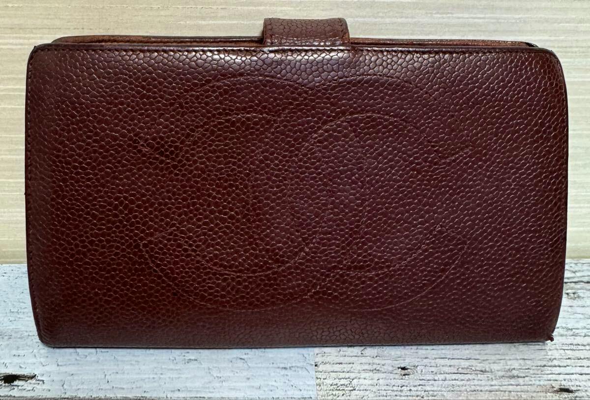 Brown cow leather long bi-fold Chanel wallet with pebbled texture and an embossed interlocking CC logo on the front.