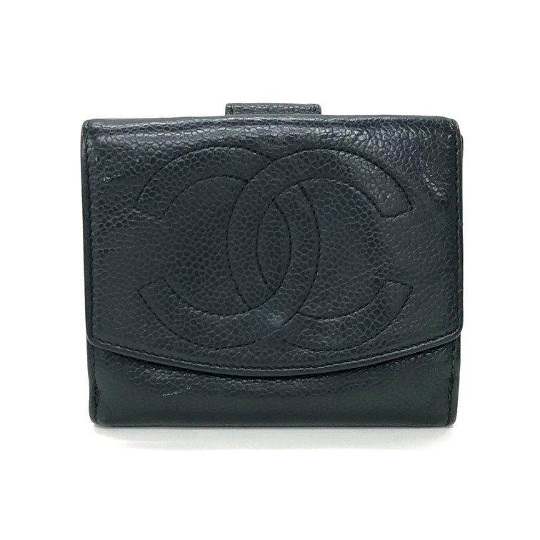 Front view of a black CHANEL bi-fold wallet in pebbled cow leather showing an embossed interlocking CC logo.