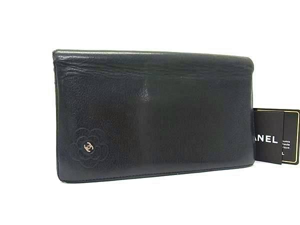 Black CHANEL cow leather bi-fold long wallet with embossed camellia and metal CC emblem shown with a CHANEL card.