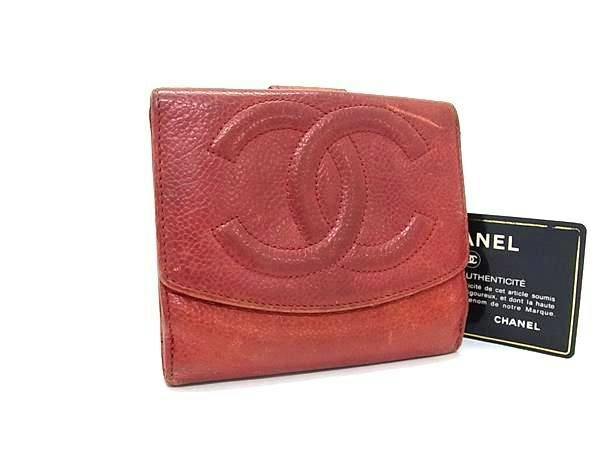 Red CHANEL caviar leather bi-fold wallet with an embossed interlocking CC logo shown with an authenticity card.