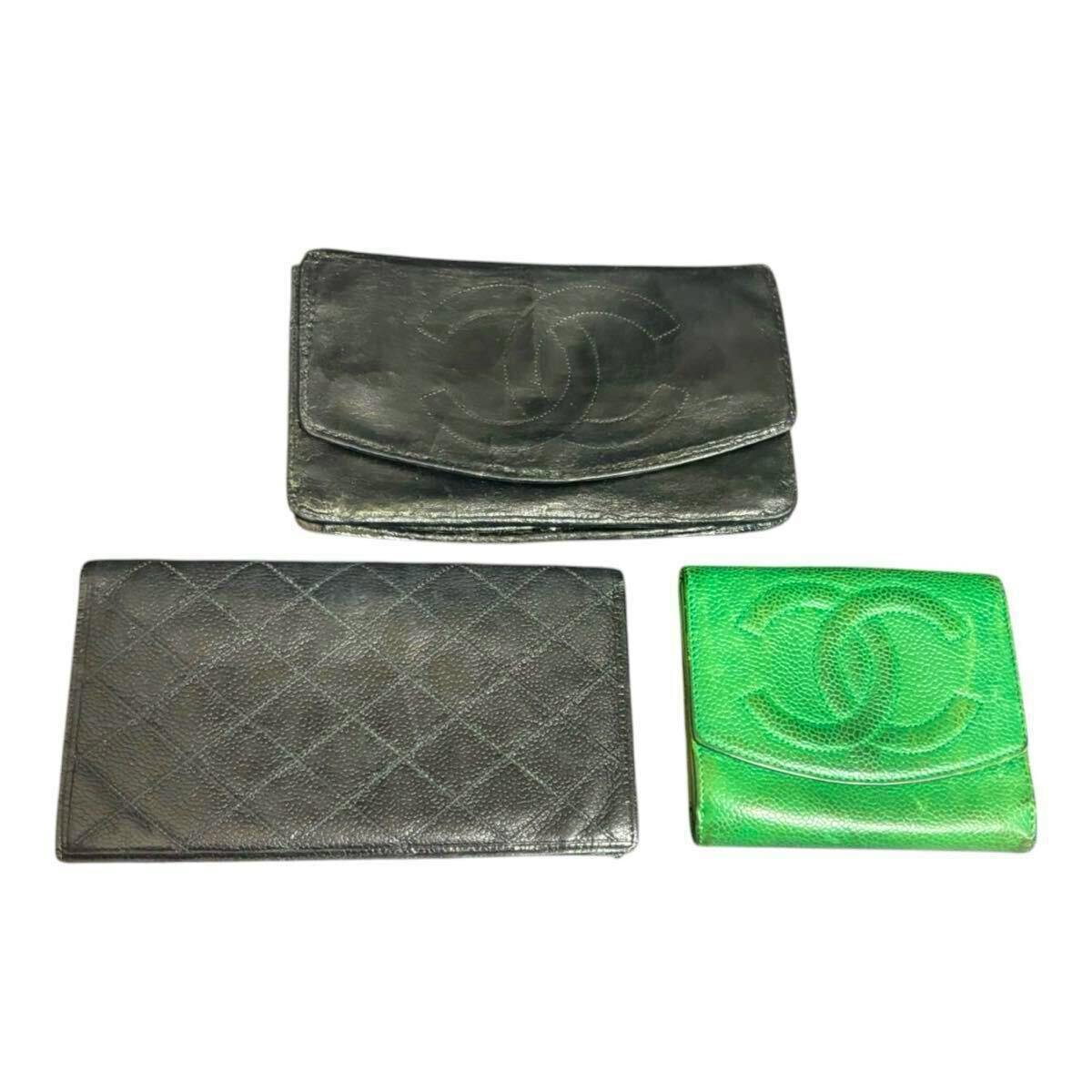 Three CHANEL wallets (two black, one green) arranged on a white background.