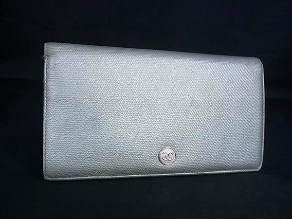 Gray CHANEL cow leather long two-fold wallet shown front-facing with the Coco logo button visible.