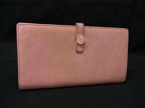 Pink CHANEL two-fold long leather wallet with a Coco-button strap displayed on a black background.