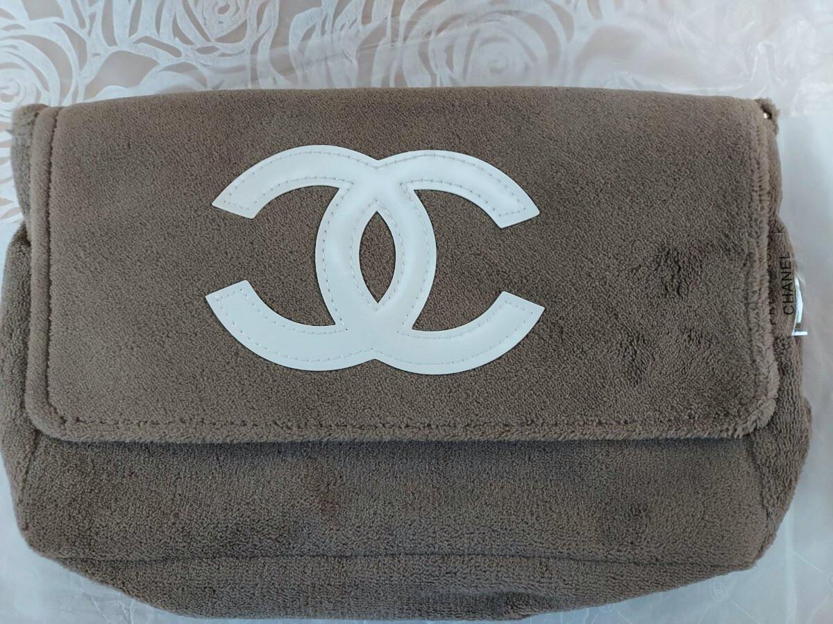 Brown cotton Chanel novelty shoulder bag with a white interlocking CC logo on the front flap.