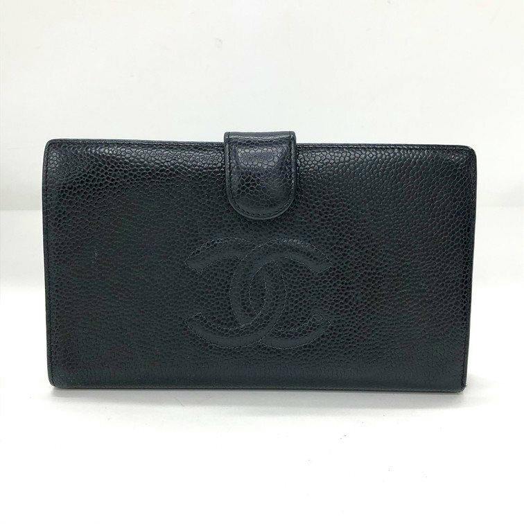 Front view of a black CHANEL cow leather bifold wallet with an embossed CC logo and a snap-tab closure.