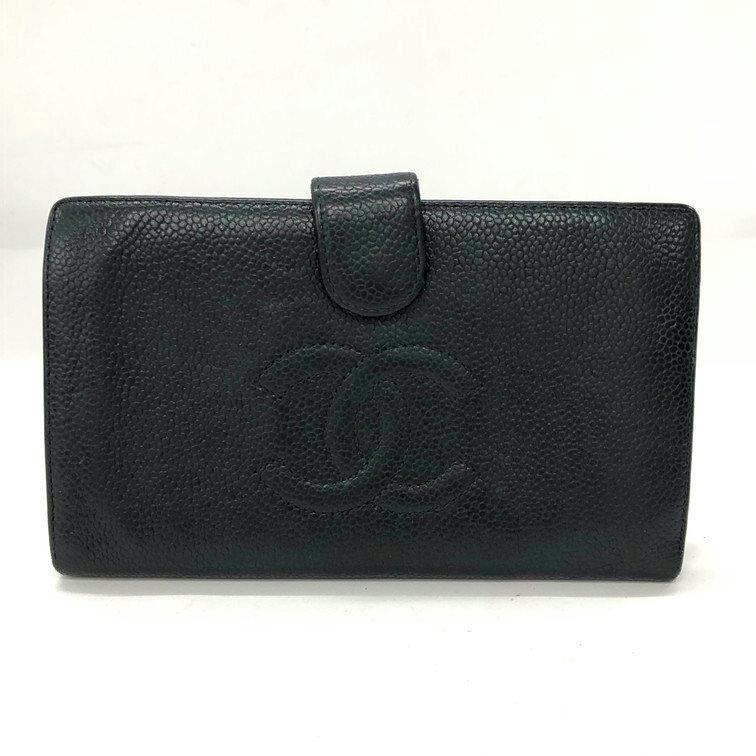 Front view of a black CHANEL cow leather bi-fold wallet showing the embossed interlocking CC logo and a snap-tab closure.