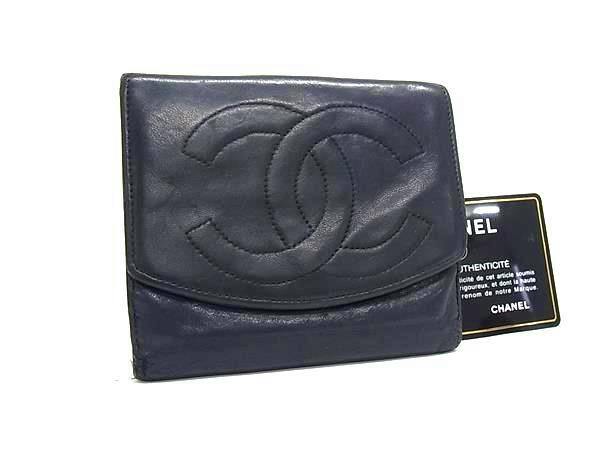 Front view of a black CHANEL bi-fold wallet with a stitched interlocking CC logo and an authenticity card visible beside it.