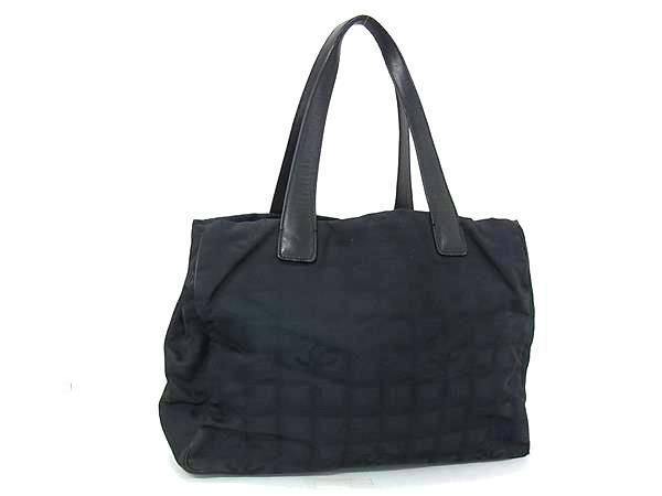 Black CHANEL nylon-and-leather New Travel Line tote handbag with double handles on a white background.