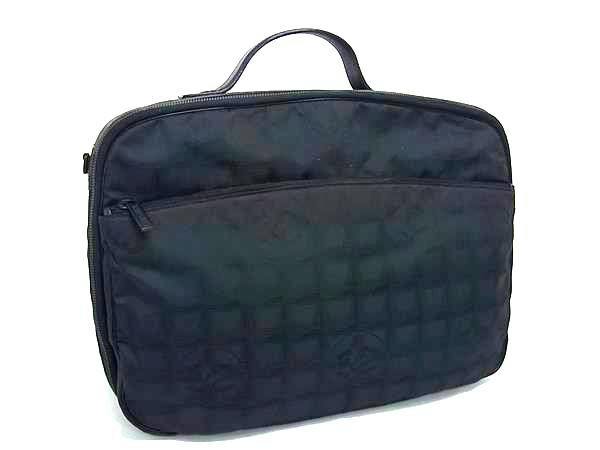 Front view of the black Chanel nylon one-handle handbag showing its quilted surface and top handle.
