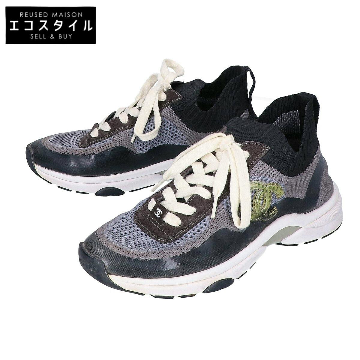 Pair of CHANEL black and grey mesh women's sneakers with white laces and visible CC logo.