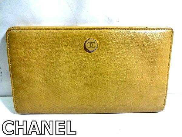Beige leather Chanel long bifold wallet with a round CC logo on the front.