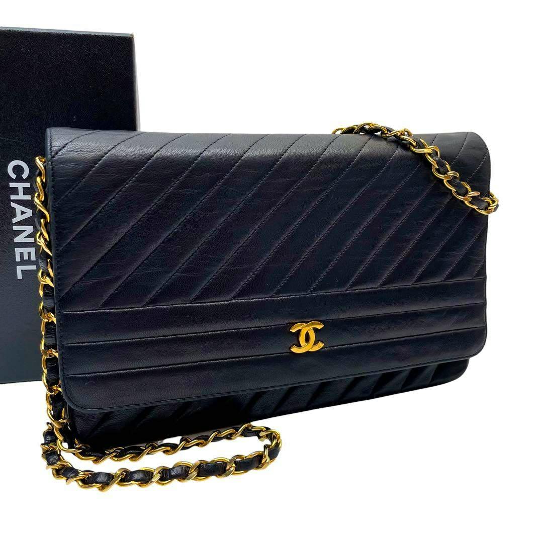 Front view of a black lambskin Chanel chain shoulder bag with diagonal stitching and a gold CC logo on the flap.