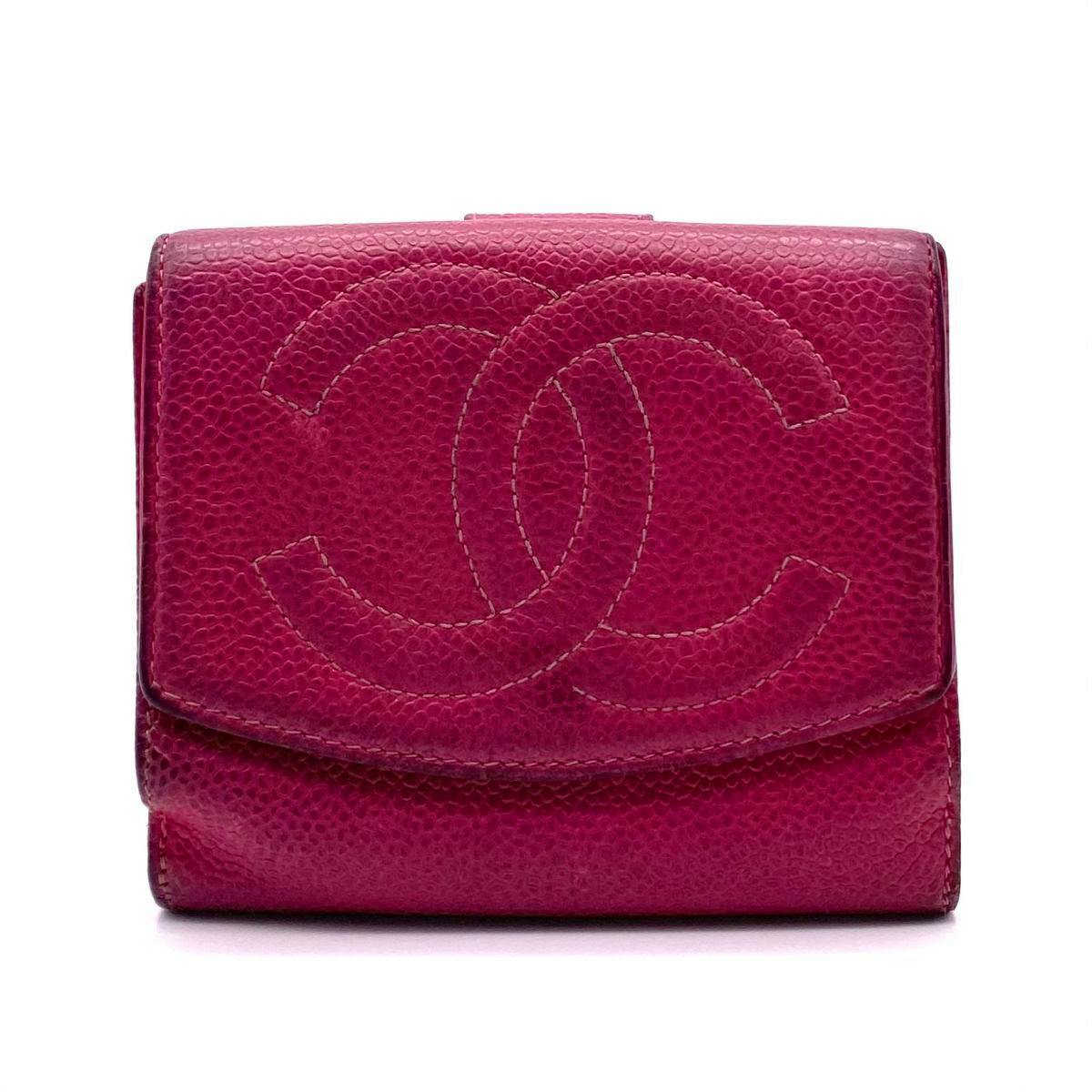 Front view of a pink CHANEL cow leather bi-fold wallet with a large stitched interlocking CC logo.