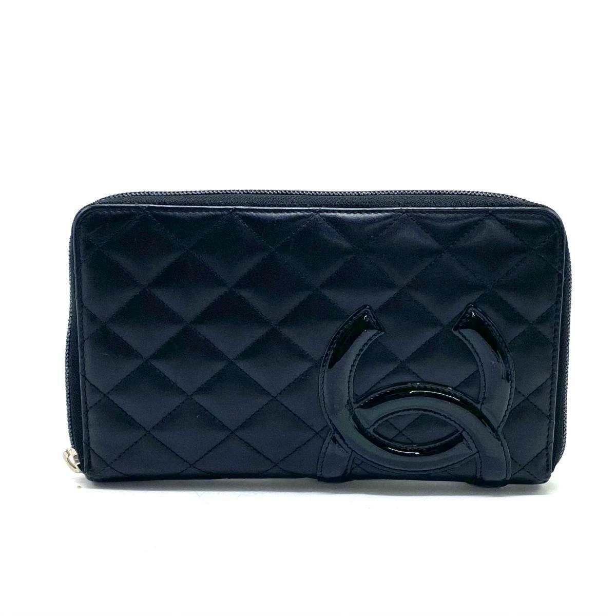 Front view of the CHANEL matelassé long round-zip leather wallet showing the quilted exterior and a large Coco logo.