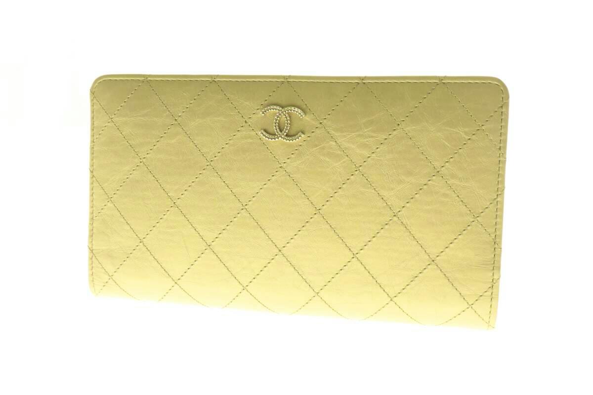 Gold quilted CHANEL long wallet showing the front with CC logo.