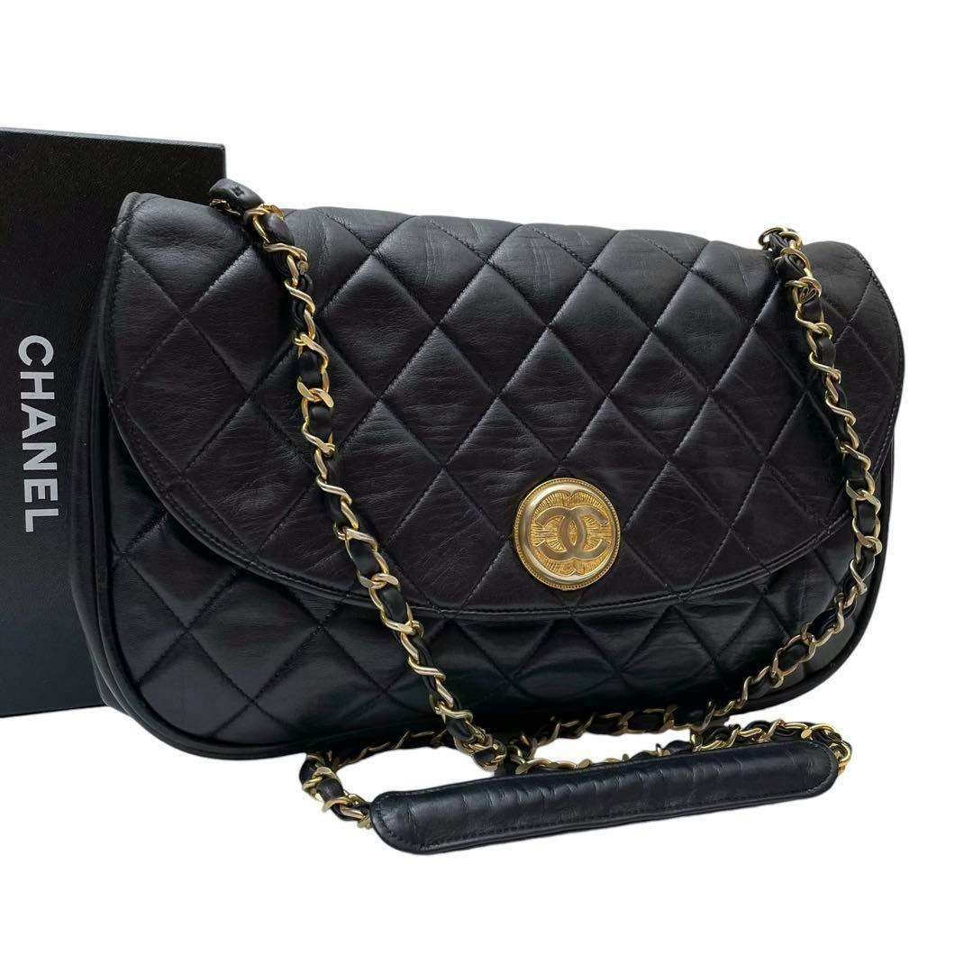 Black quilted (matelassé) lambskin Chanel chain-shoulder bag with a gold CC medallion on the front.