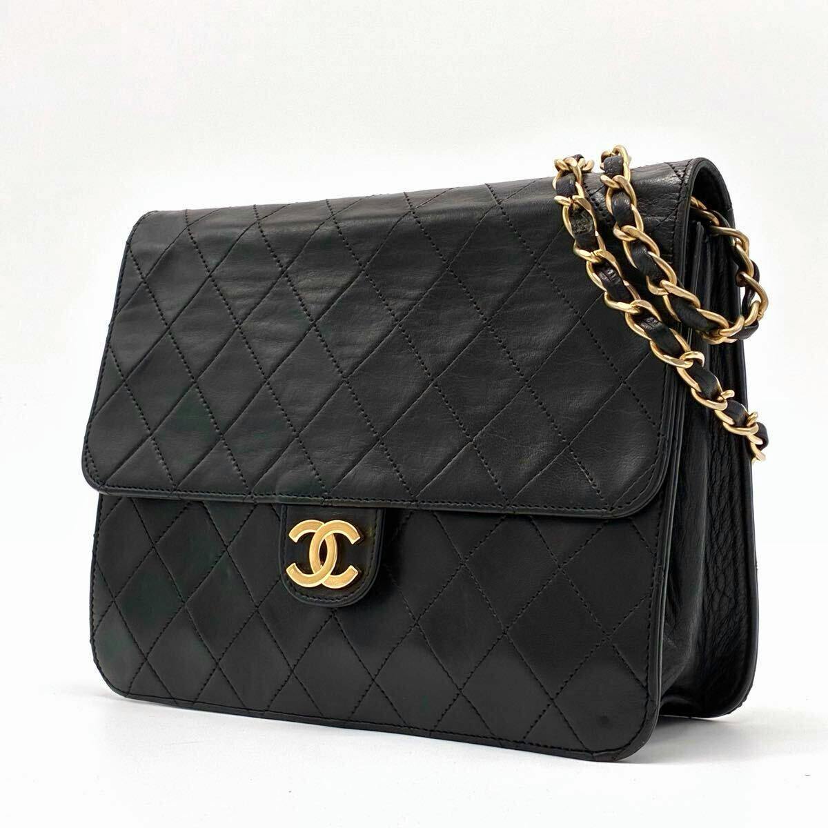 Black quilted lambskin Chanel Matelassé flap shoulder bag with gold CC push-lock and chain strap on a white background.