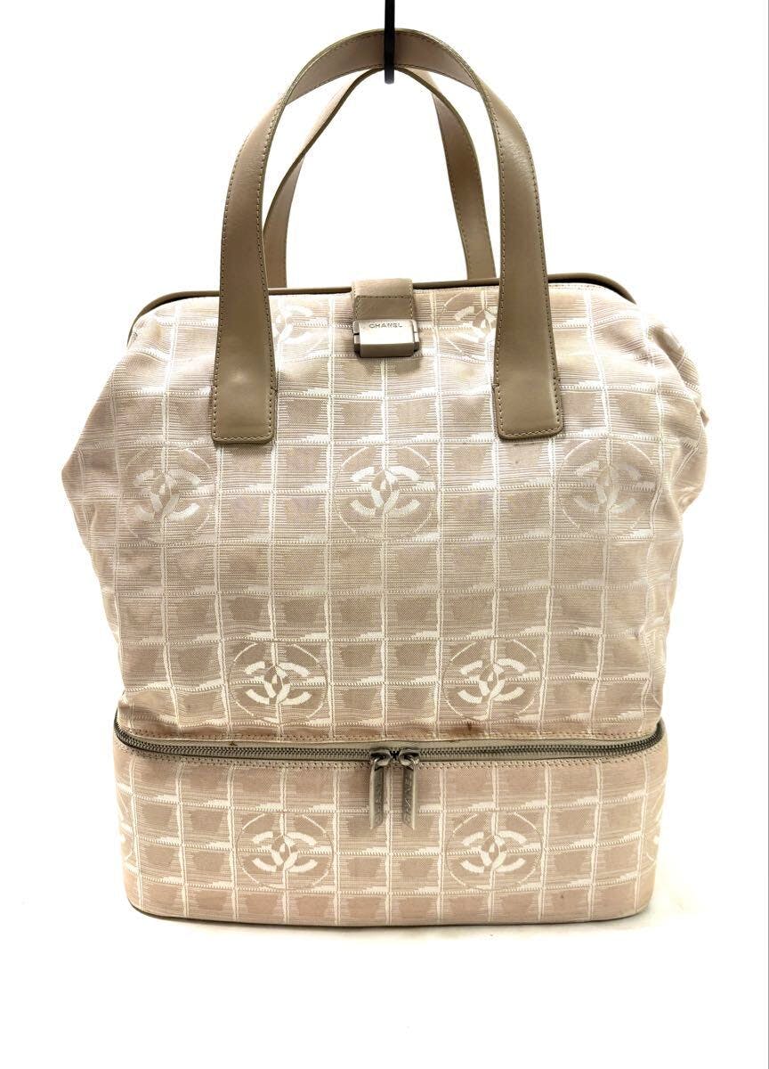 Front view of the beige CHANEL New Travel Line nylon jacquard boston bag with leather handles, silver hardware, and a bottom zip compartment.