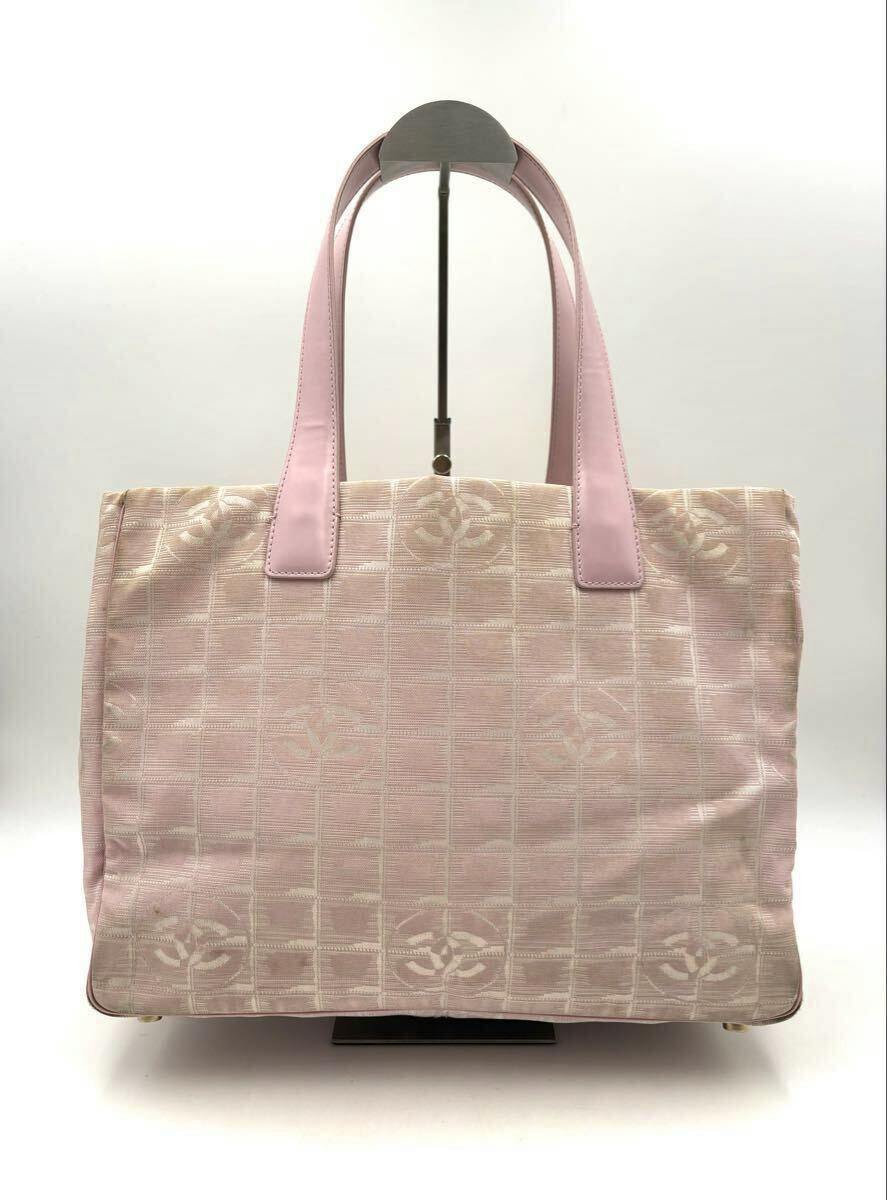 Front view of the pink CHANEL New Travel Line PM canvas tote bag with top handles and a subtle checkerboard pattern with CC logos.
