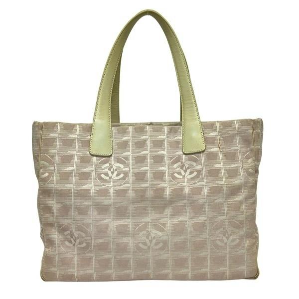 Front view of a CHANEL Neutravel Line MM tote bag in light pink and ivory canvas with leather handles and repeating CC motif.