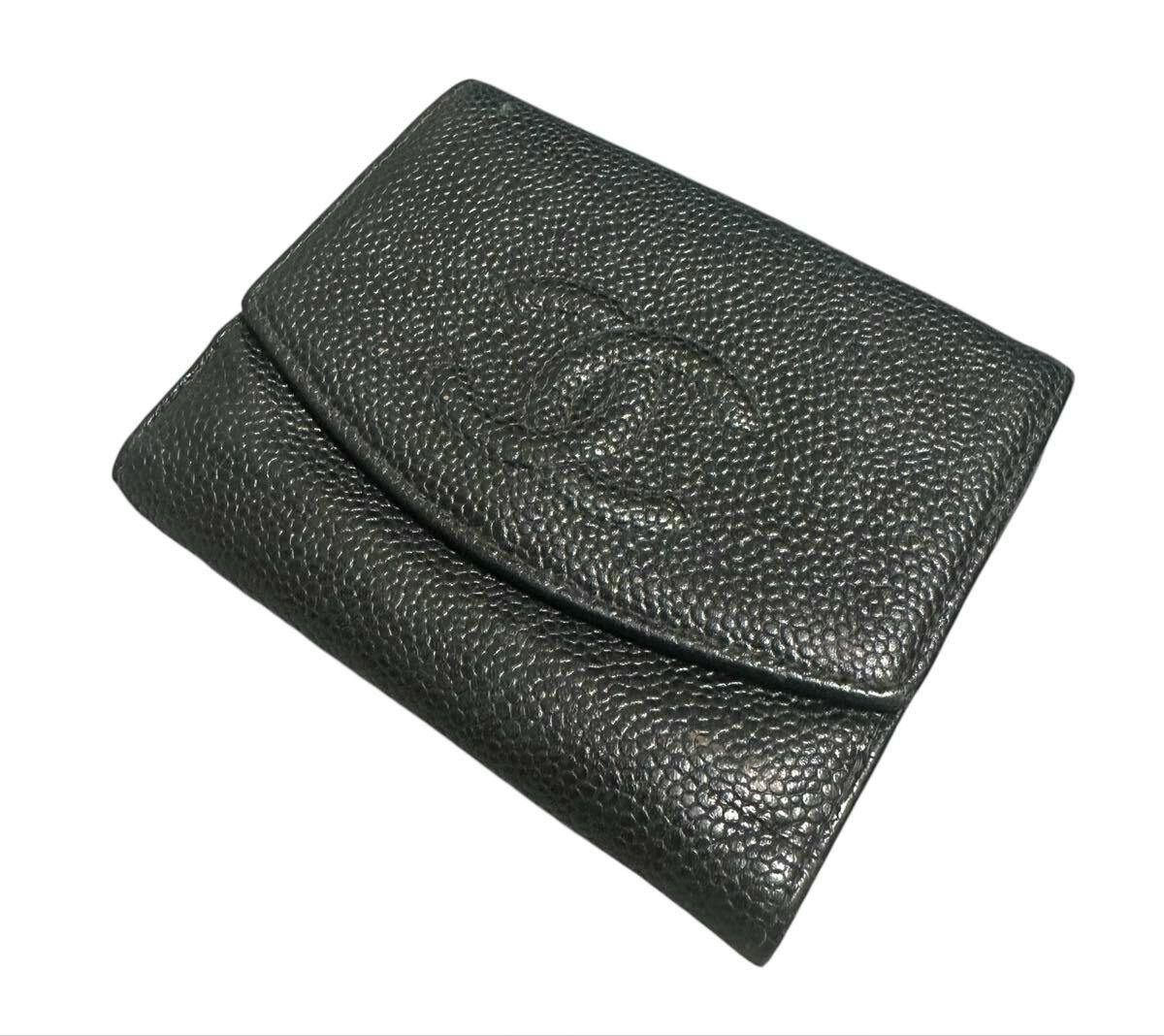 Black Chanel bi-fold wallet in caviar-grain embossed leather with an embossed interlocking CC on the front, shown closed on a white background.
