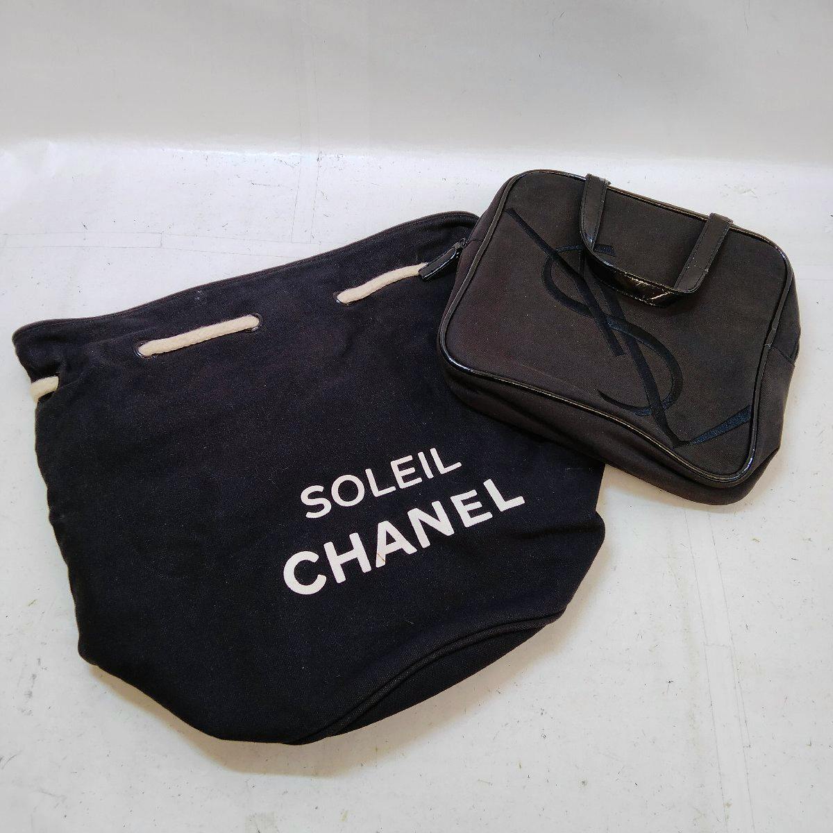 Two black bags on a white background: a fabric CHANEL bag printed "SOLEIL CHANEL" next to a small black YSL bag with a stitched logo.