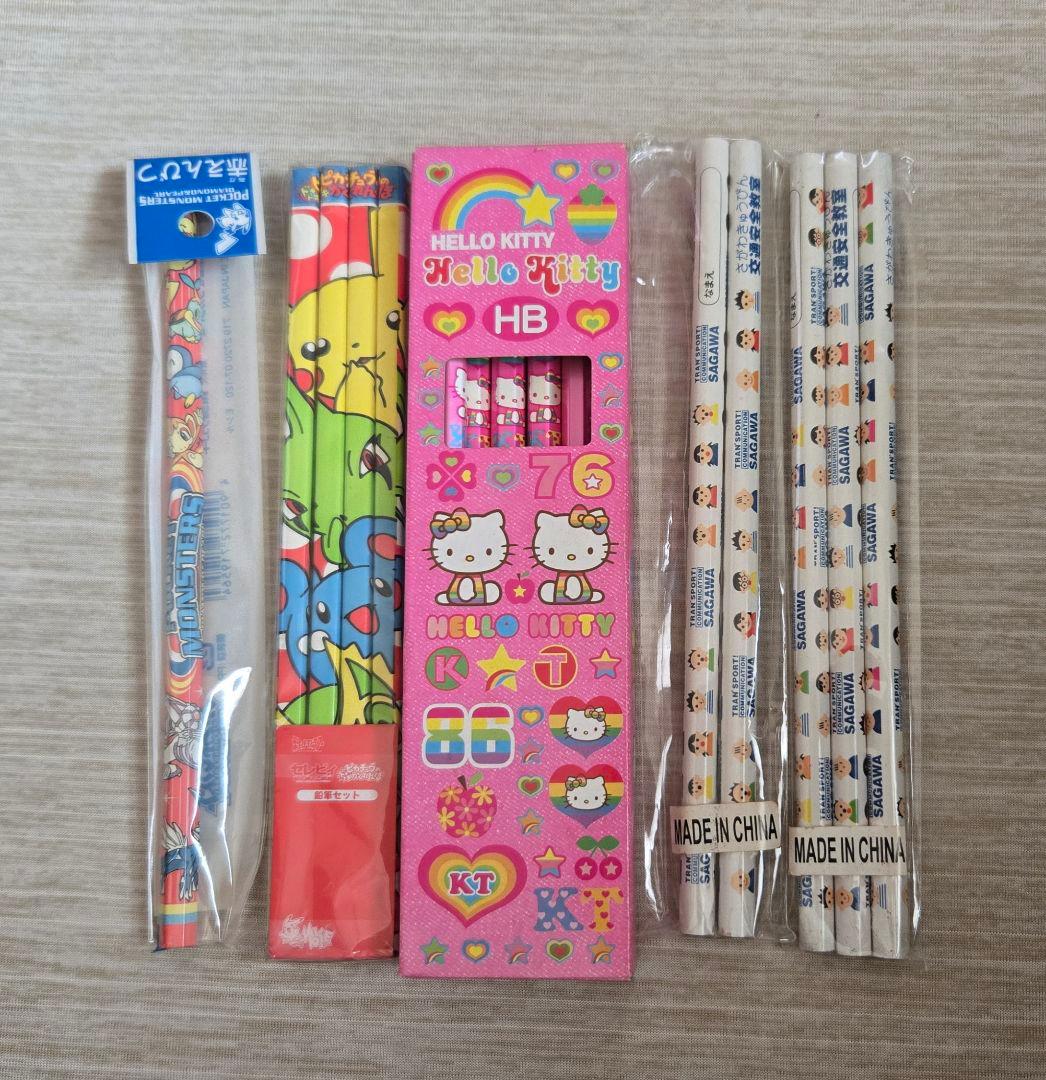 Main image shows a character pencil set with a pink Hello Kitty pencil box and multiple wrapped pencils on a light tabletop.