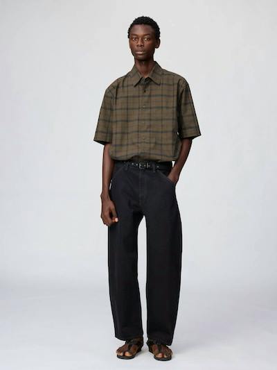 Male model wearing the boxy short-sleeve checked men's cotton shirt shown front on.