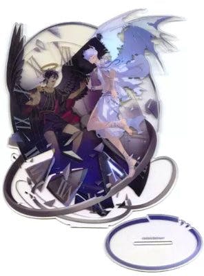 Acrylic stand showing two illustrated characters in contrasting dark and light outfits alongside an oval display base.